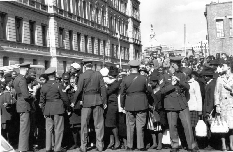 Alf Khumalo: South Africa goes on trial. Police outside the court. The whole world was watching when the three major sabotage trials started in Pretoria, Cape Town and Maritzburg. Outside the palace of Justice during the Rivonia Trial, 1963. Courtesy of Bailey’s Archive © Bailey's Archives