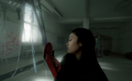 A Person visible from the side is standing in an empty building.
