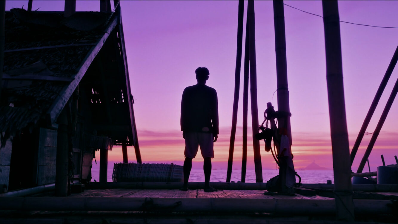 A man is watching the sun set