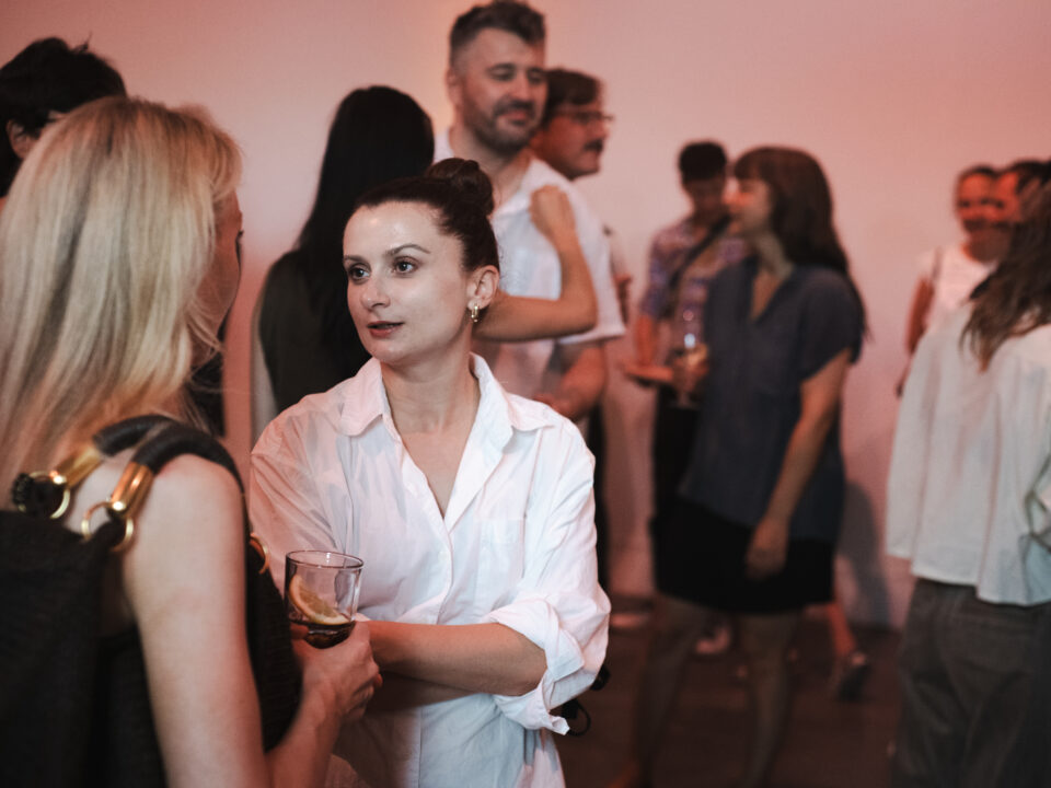 Two people in conversation during an event.